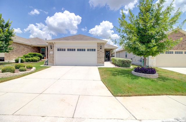 single story home featuring a garage and a front lawn