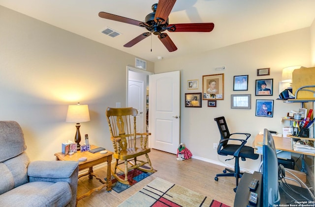 home office with ceiling fan and light hardwood / wood-style flooring