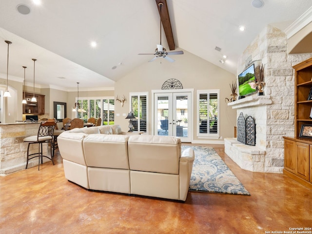 living room with ceiling fan, french doors, a wealth of natural light, a fireplace, and beam ceiling