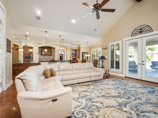 living room with french doors, high vaulted ceiling, and ceiling fan with notable chandelier