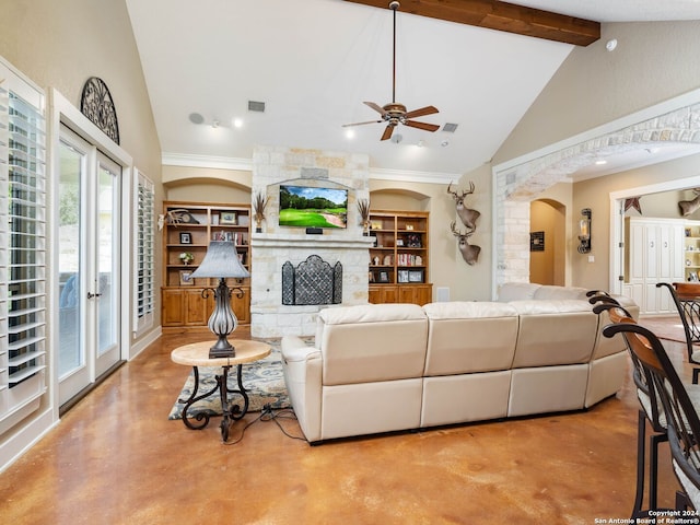 living room featuring a stone fireplace, lofted ceiling with beams, ceiling fan, ornamental molding, and built in shelves