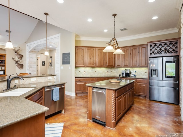 kitchen featuring stainless steel appliances, decorative light fixtures, concrete flooring, and sink