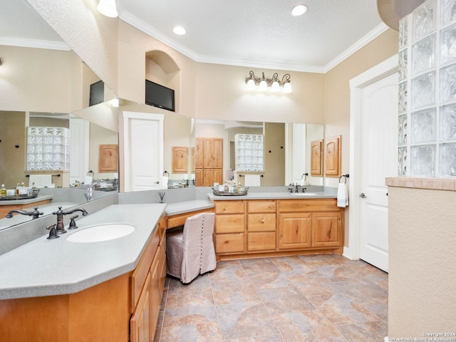 bathroom with vanity, a textured ceiling, and crown molding