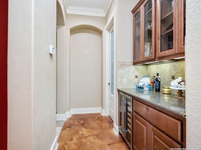 bar with wine cooler, crown molding, dark stone counters, concrete flooring, and backsplash