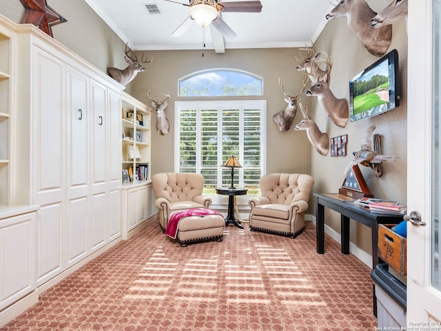 sitting room with ceiling fan and crown molding