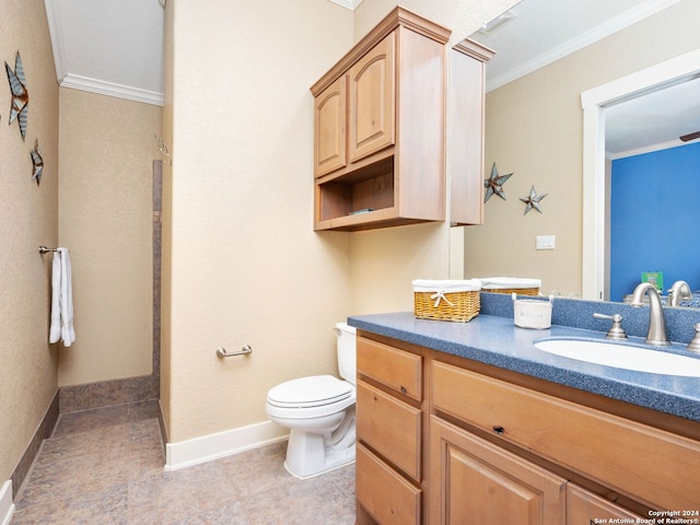 bathroom with crown molding, vanity, and toilet