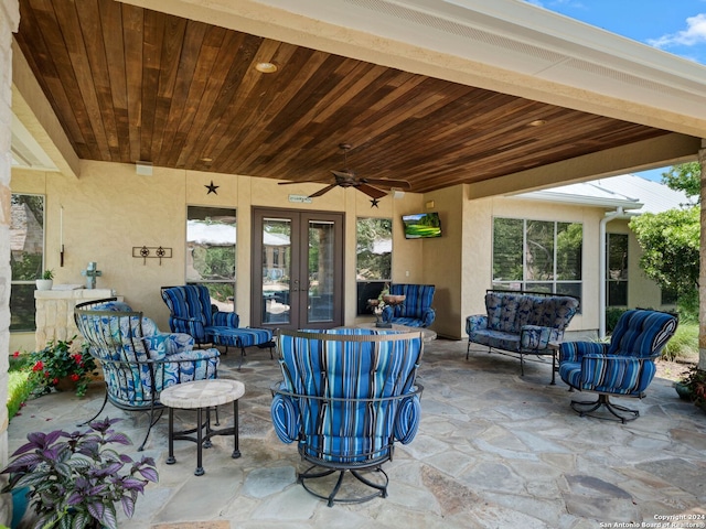 view of patio / terrace with ceiling fan, french doors, and an outdoor living space