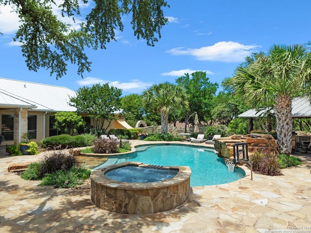 view of swimming pool with an in ground hot tub and a patio area