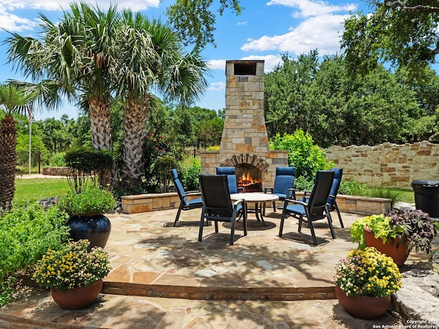 view of patio / terrace featuring an outdoor stone fireplace