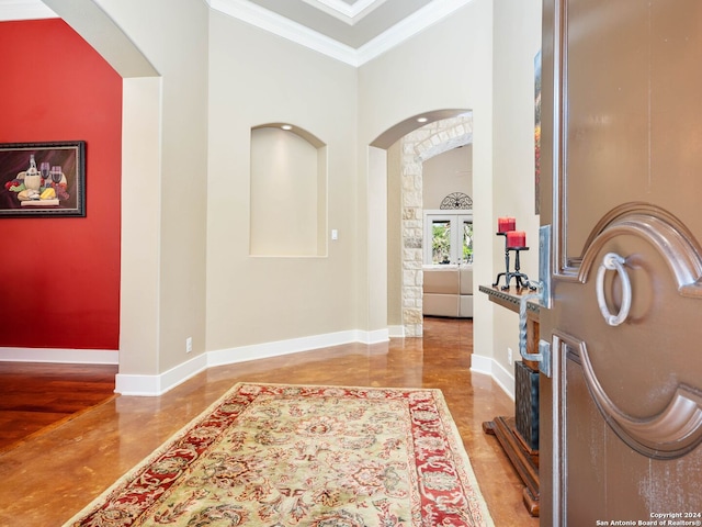 entrance foyer featuring a towering ceiling, french doors, and ornamental molding