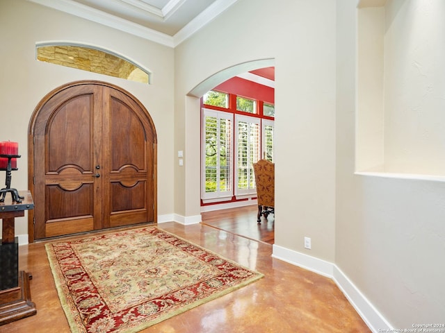 entrance foyer featuring a high ceiling and crown molding