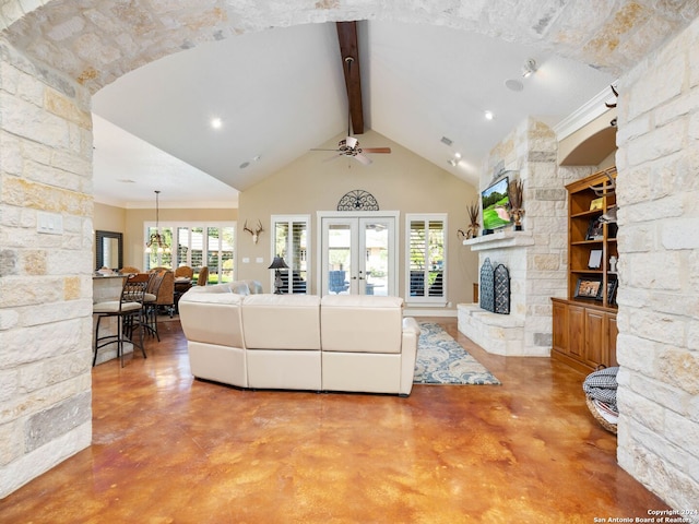 living room featuring a fireplace, concrete flooring, ceiling fan, and beamed ceiling