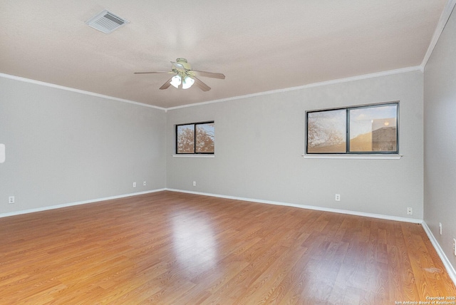 empty room featuring hardwood / wood-style floors, ceiling fan, and crown molding