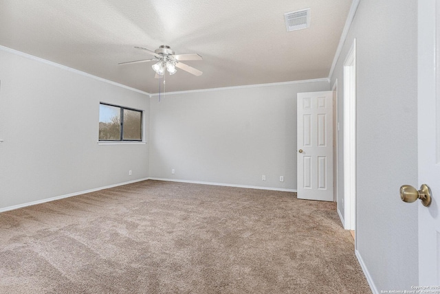 carpeted spare room featuring a textured ceiling, ceiling fan, and ornamental molding