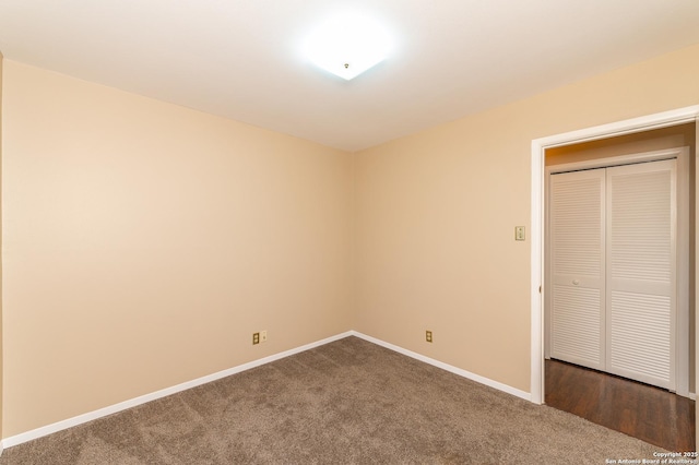 unfurnished bedroom with a closet and carpet floors