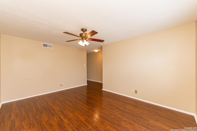 empty room featuring dark wood-type flooring and ceiling fan