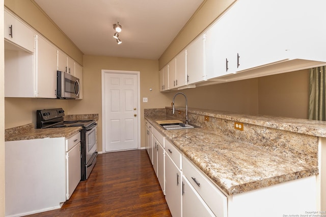 kitchen featuring sink, dark hardwood / wood-style flooring, white cabinets, and black / electric stove