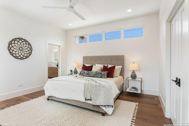 bedroom with ceiling fan, dark wood-type flooring, connected bathroom, and multiple windows