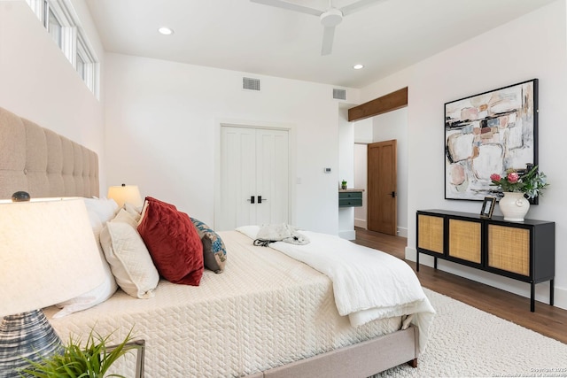 bedroom featuring wood-type flooring, a closet, and ceiling fan