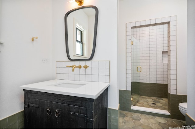 bathroom featuring vanity, tile patterned floors, a shower with shower door, and toilet