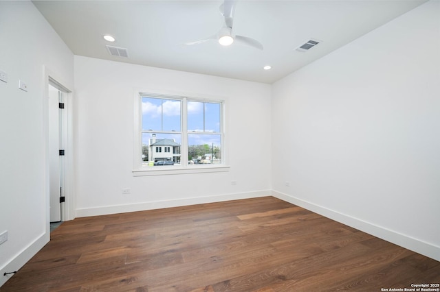 empty room with ceiling fan and dark hardwood / wood-style floors