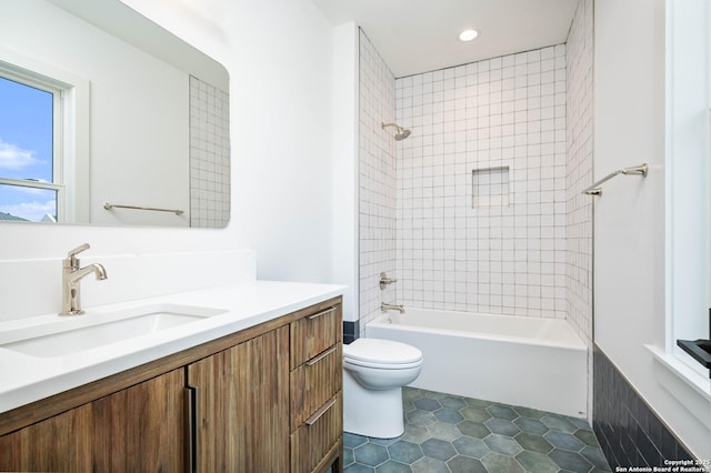 full bathroom with toilet, tiled shower / bath combo, tile patterned flooring, and vanity