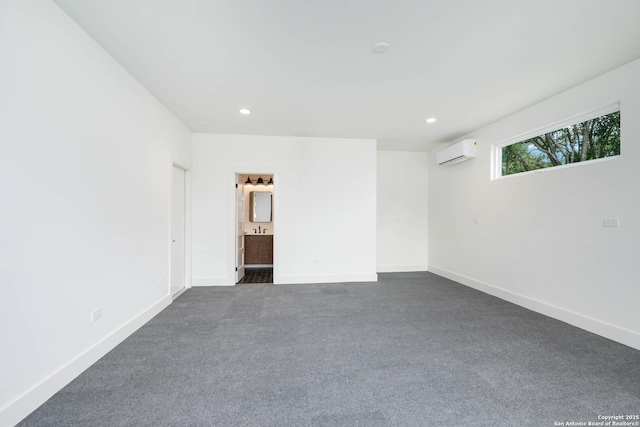 carpeted spare room featuring a wall mounted air conditioner