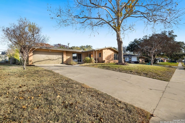 ranch-style home featuring a front lawn and a garage