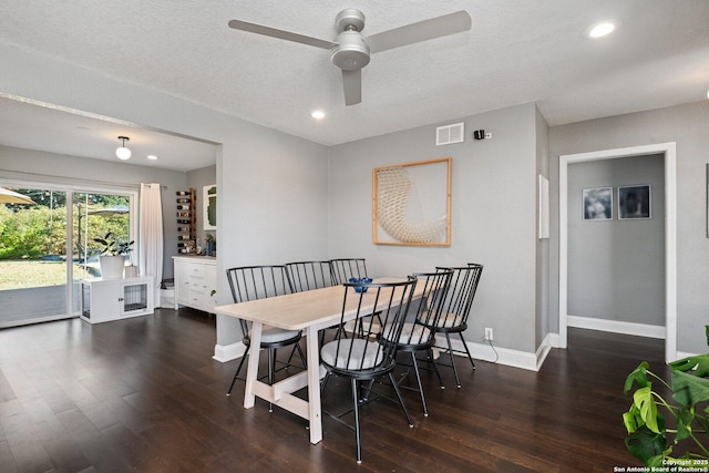 dining room with a textured ceiling, ceiling fan, and dark hardwood / wood-style floors