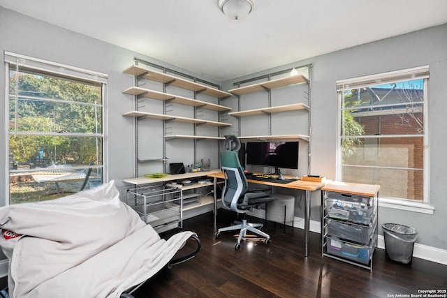 office area with plenty of natural light and dark hardwood / wood-style floors