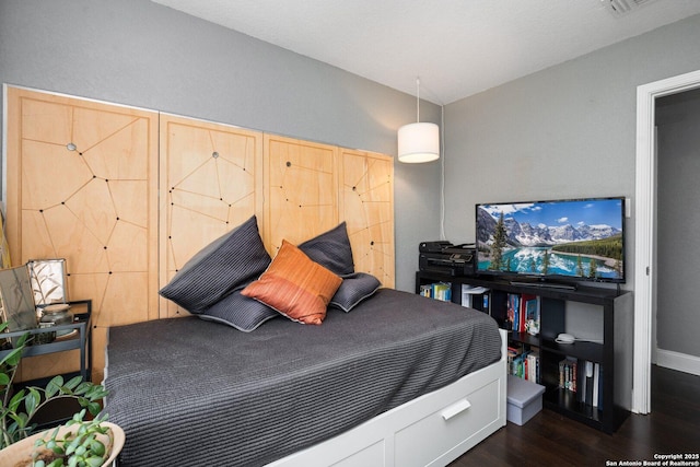 bedroom featuring dark wood-type flooring