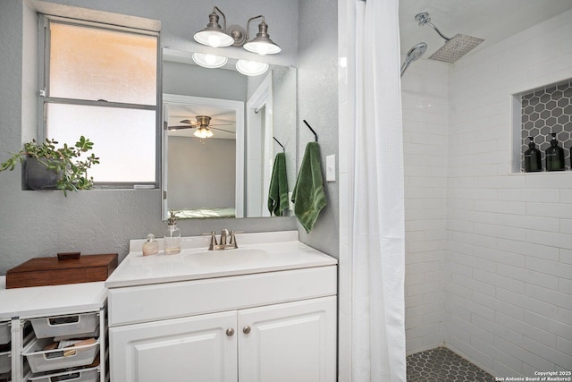 bathroom with curtained shower, ceiling fan, and vanity