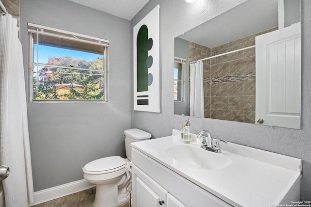 bathroom with a shower with curtain, vanity, and toilet