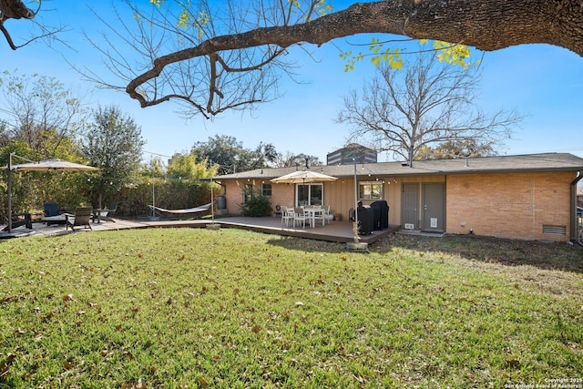 back of property with a patio and a lawn