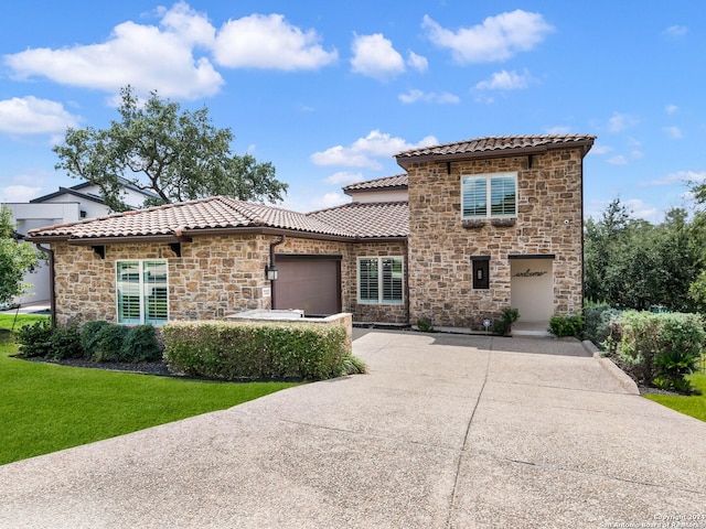 view of front facade featuring a front yard and a garage