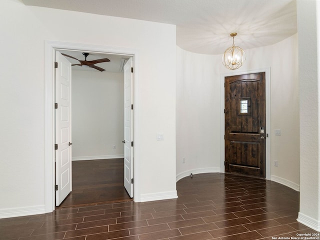 entryway with ceiling fan with notable chandelier