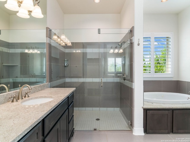 bathroom featuring an inviting chandelier, plus walk in shower, tile patterned floors, and vanity