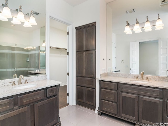 bathroom featuring vanity, tile patterned flooring, and a shower with shower door