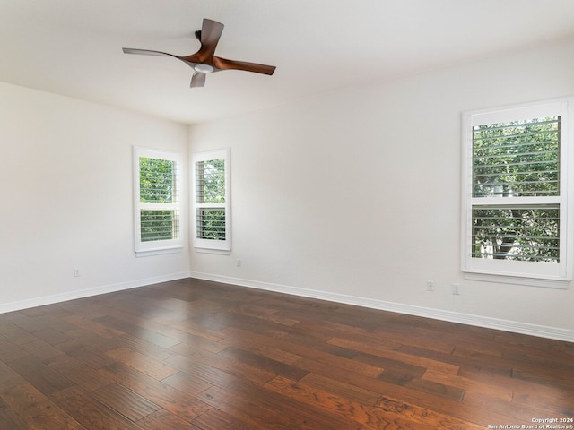 empty room featuring ceiling fan and dark hardwood / wood-style flooring