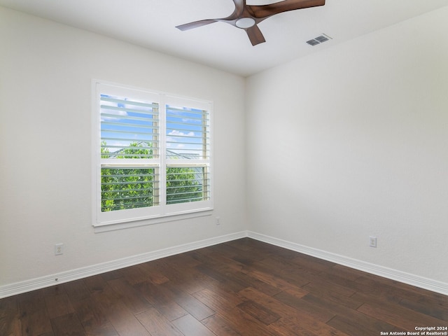 spare room featuring ceiling fan and dark hardwood / wood-style floors