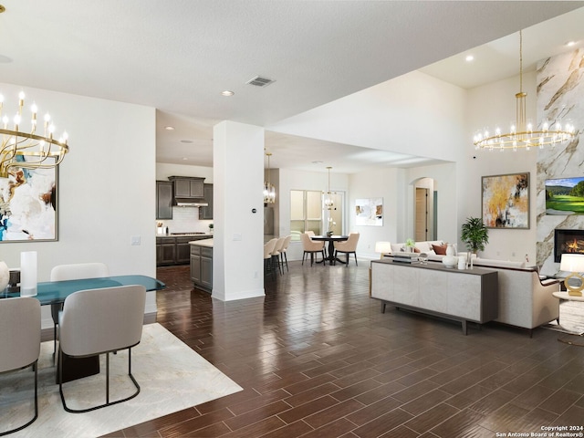 living room featuring a premium fireplace and a chandelier