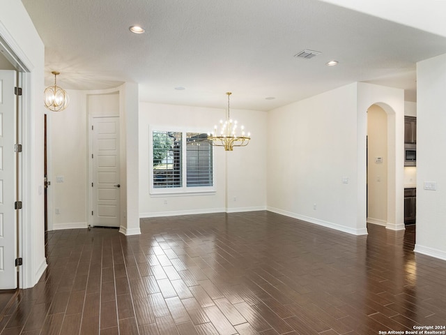 unfurnished room with a chandelier