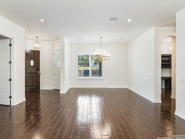 spare room featuring an inviting chandelier