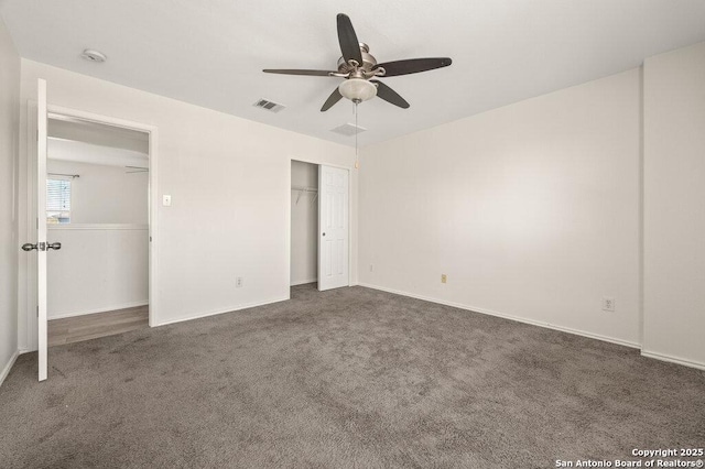 unfurnished bedroom with ceiling fan and dark carpet