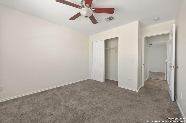 unfurnished bedroom featuring carpet floors, ceiling fan, and a closet