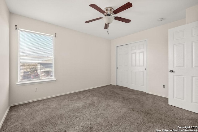 unfurnished bedroom featuring a closet, ceiling fan, and dark colored carpet