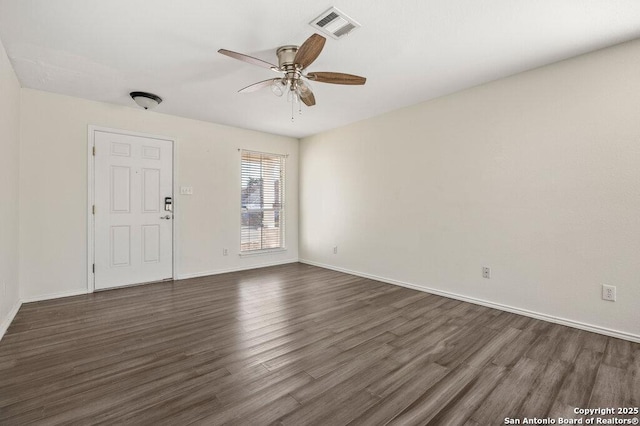 empty room featuring ceiling fan and dark hardwood / wood-style floors