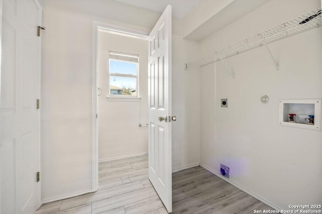 laundry room with washer hookup, light wood-type flooring, hookup for a gas dryer, and electric dryer hookup