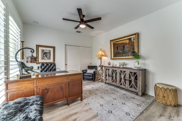 office with ceiling fan and light hardwood / wood-style flooring