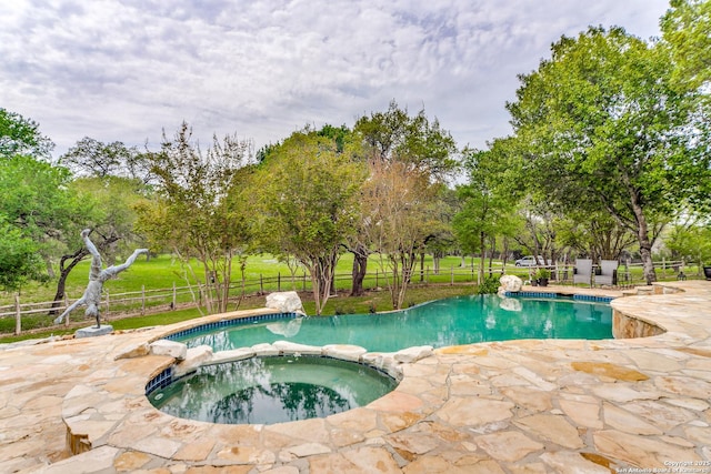 view of swimming pool with a patio and an in ground hot tub